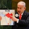 Israeli Prime Minister Benjamin Netanyahu holds up a map Friday while speaking at the 80th session of the United Nations General Assembly, at U.N. headquarters.