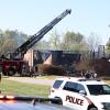 Firefighters and law enforcement officers stand outside the Church of Jesus Christ of Latter-day Saints in Grand Blanc Township, Mich., on Sunday. The church is severely damaged by a fire.