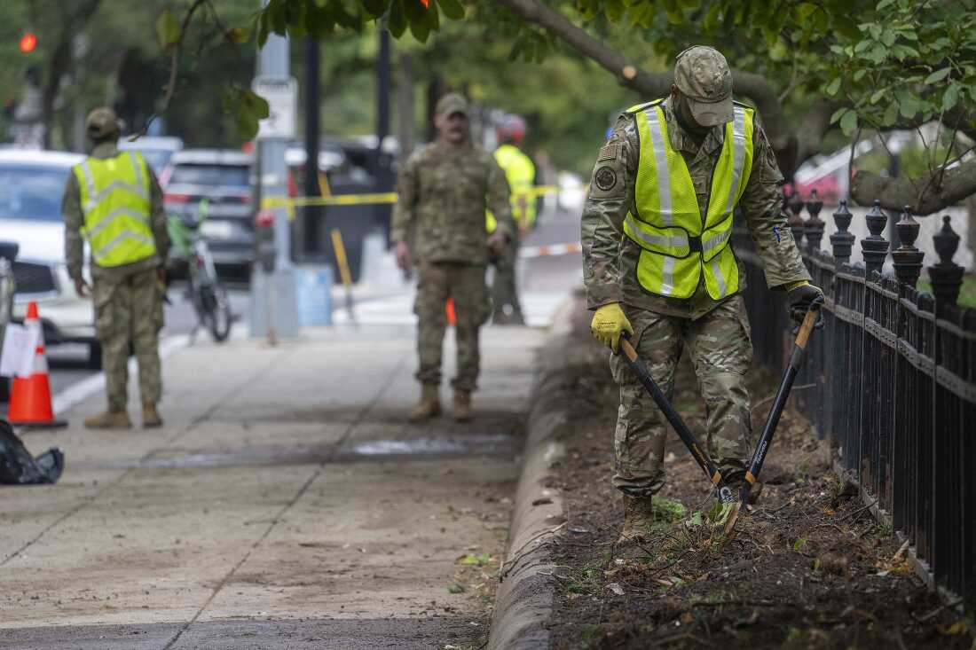 National Guard members weed an area as they clean up a park near in Washington, DC, on September 18.