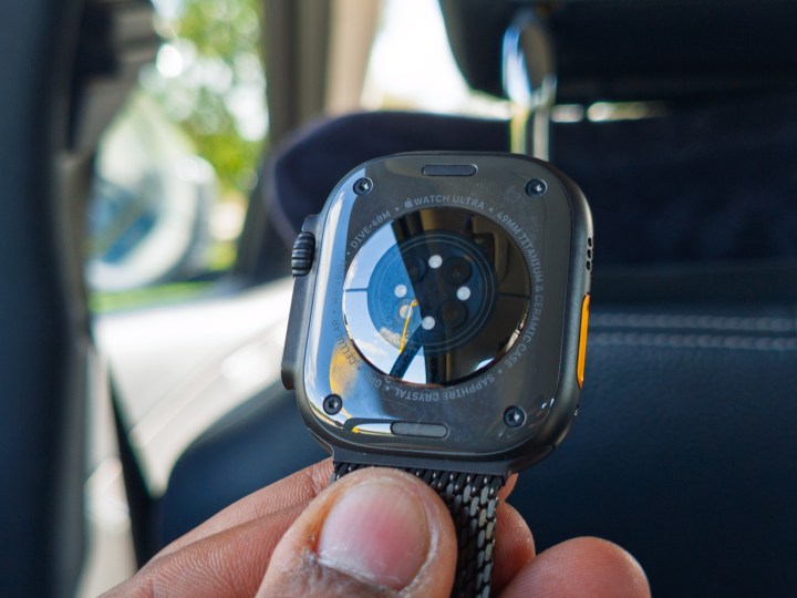 Sensors on the underneath of the Apple Watch Ultra 3 in black titanium on a hand