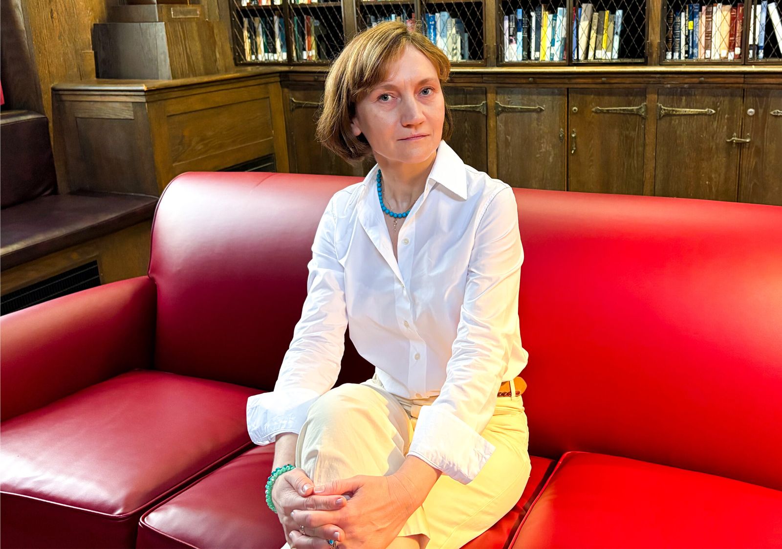 Woman couch and bookshelf