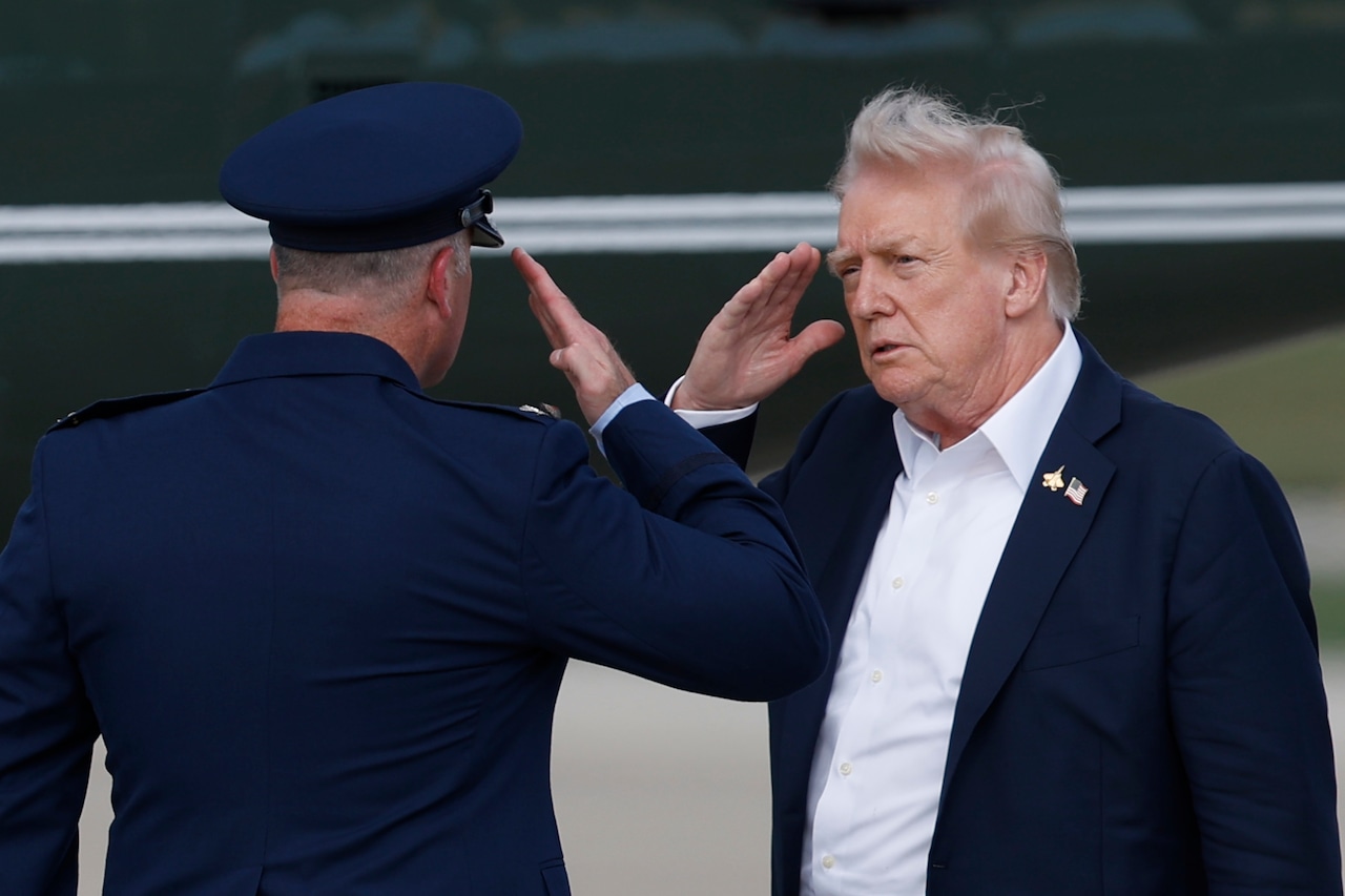 President Donald Trump salutes an Air Force officer