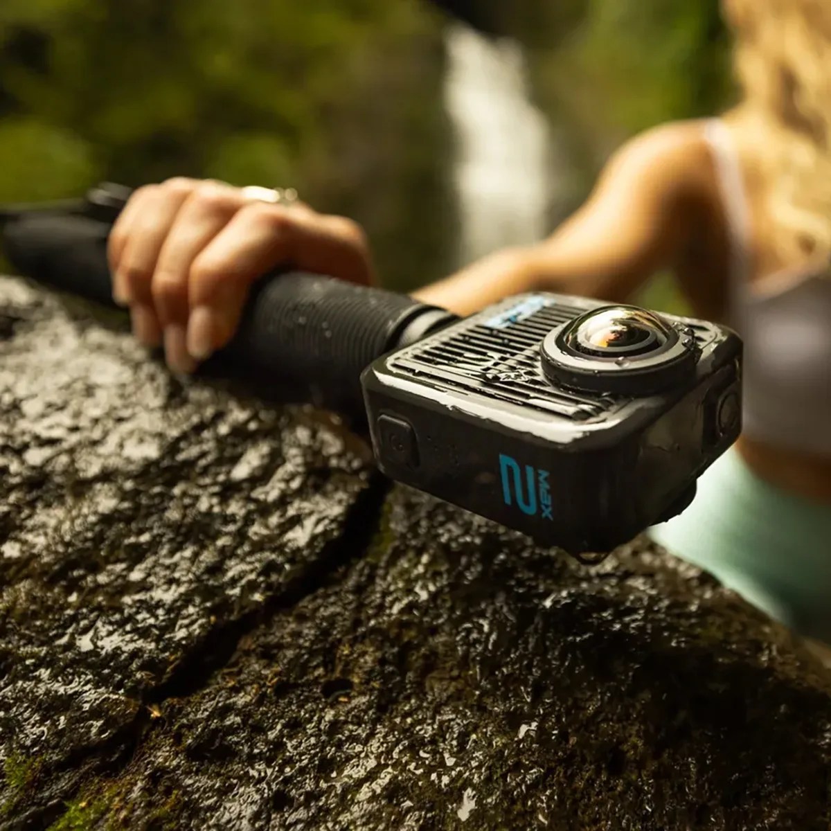 A close-up of a black action camera labeled 